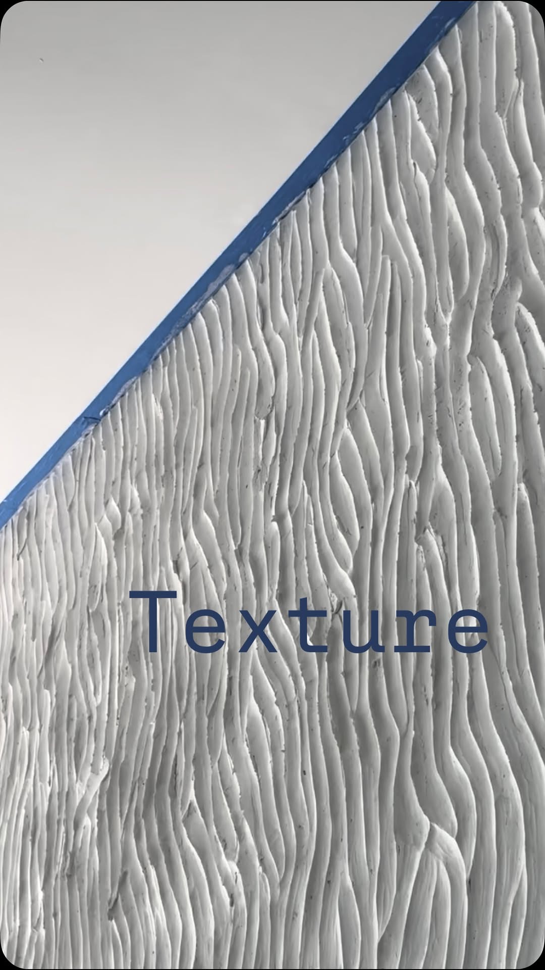 Close-up of hand-sculpted plaster texture in raking light